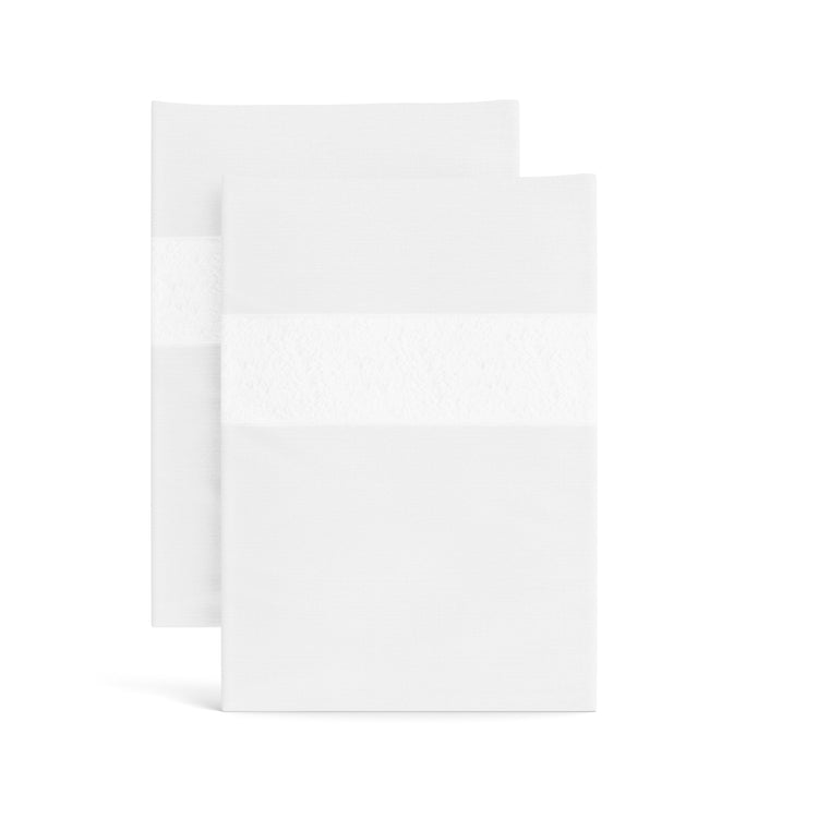 Stacked white Minaudiere pillowcases from the Judith Leiber Couture x Ann Gish collection, detailed with an ivory sequined border band that echoes the jeweled Minaudiere motif. - PCMIK‑WHI‑BON PCMIS‑WHI‑BON