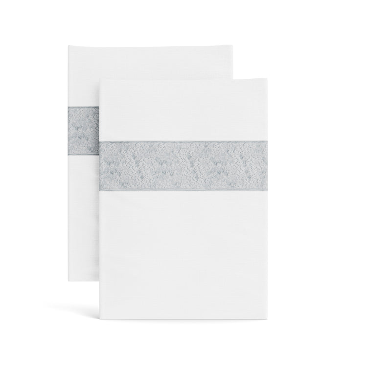 Stacked white Minaudiere pillowcases from the Judith Leiber Couture x Ann Gish collection, detailed with a silver sequined border band that echoes the jeweled Minaudiere motif. - PCMIK‑WHI‑SIL PCMIS‑WHI‑SIL