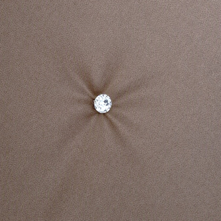 A single round clear crystal or gemstone stud with a silver-toned setting, centered on a soft, metallic fabric background. Swatch of Monaco Crystal in Metal - COMOK-MET-SIL COMOQ-MET-SIL THMOK-MET-SIL